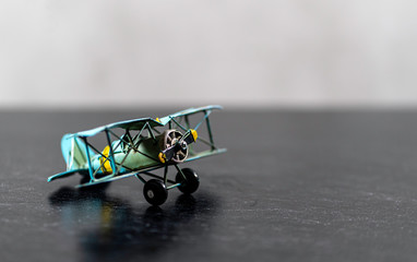 Small Biplane model on grey background green yellow © olga_demina