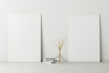 Two blank vertical posters. frame mock up standing on white floor next to white wall with vase and books. Clipping path around posters. 3d illustration