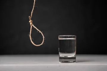Fotobehang alcohol is killing your body, rope loop near the glass, alcoholism addiction concept © Mihail