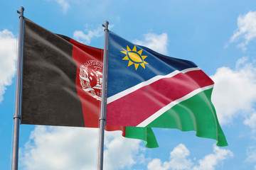 Namibia and Afghanistan flags waving in the wind against white cloudy blue sky together. Diplomacy concept, international relations.