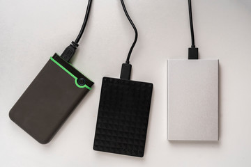 three external hdd drives one the shelf, data backup storage