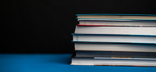 a simple stack of books on the shelf at home