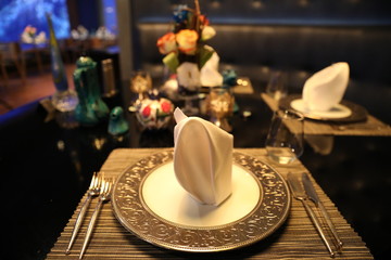 Elegant table setting with fork, knife and red napkin