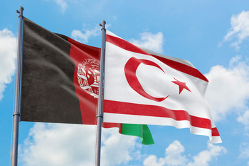 Northern Cyprus and Afghanistan flags waving in the wind against white cloudy blue sky together. Diplomacy concept, international relations.