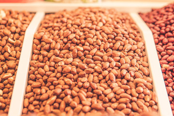 peeled peanuts in the store. different varieties of peanuts.