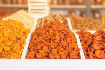 organic dried apricots of different varieties on the shelf of a food store.