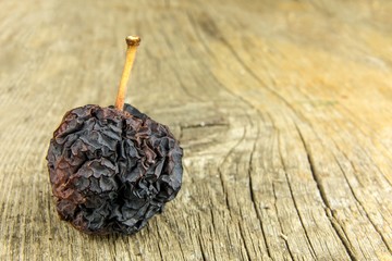 Shriveled apple. Old apple. Wrinkled apple texture. Dry skin. Old withered fruit.