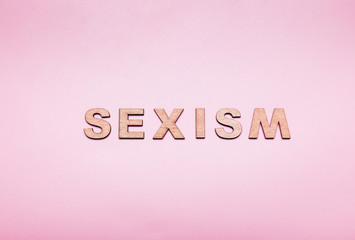 The word sexism in on a pink background