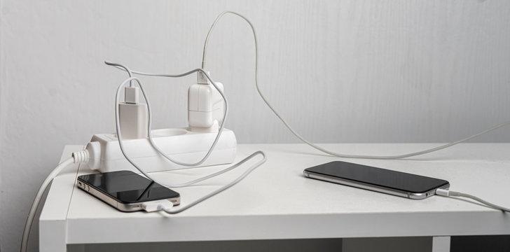 a socket with a phone wire quick charger on the white shelf