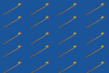 Toothbrush minimal pattern on blue background. Trendy stylish health care concept.