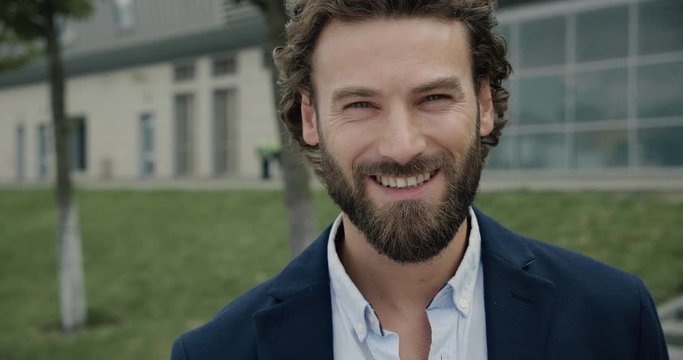 Portrait confident handsome Businessman smiling happy to the Camera. Man proud enjoying successful startup Company near modern Office Center. Man gets real Emotions. Men. Attractive People. Success.