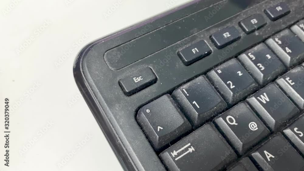 Poster pressing the escape button on an old dirty computer keyboard