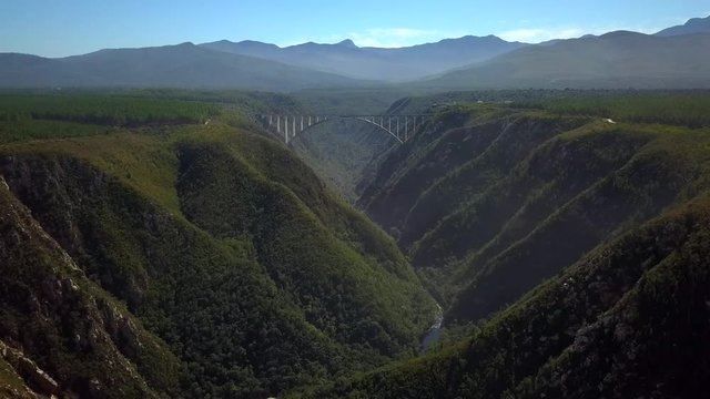 Beautiful Scenic Bloukrans Bridge Soaring Over River & Valley, Africa, Aerial Pull Back Reveal Motion