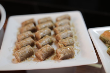Close up of traditional oriental sweet pastry cookies known as backlava, Turkish desert with sugar, honey, walnuts and pistachio