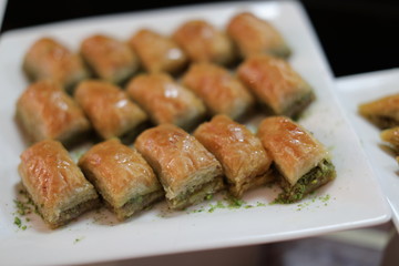 Close up of traditional oriental sweet pastry cookies known as backlava, Turkish desert with sugar, honey, walnuts and pistachio