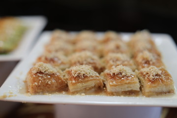 Close up of traditional oriental sweet pastry cookies known as backlava, Turkish desert with sugar, honey, walnuts and pistachio