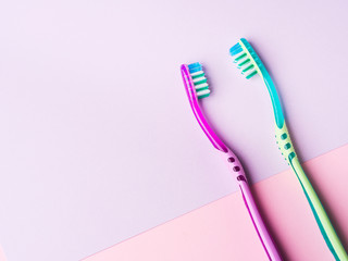 Two toothbrushes for a couple on pastel pink