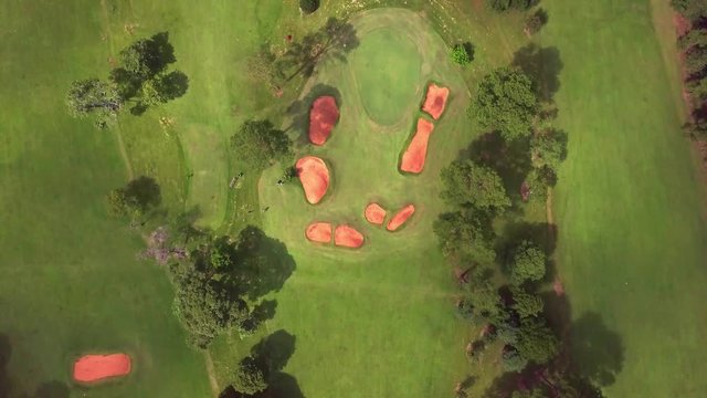 golf players at the green. Golf club Tacuru, argentina, south america. Drone air view.  Green and fairway. Upward cam movement.
