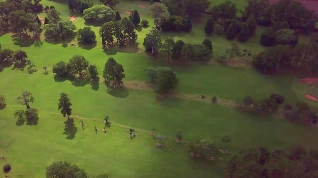 golf club Tacuru, argentina, south america. Air view drone footage. Sunshine and shadows on the fairway. trees. Pan left - anti clockwise.