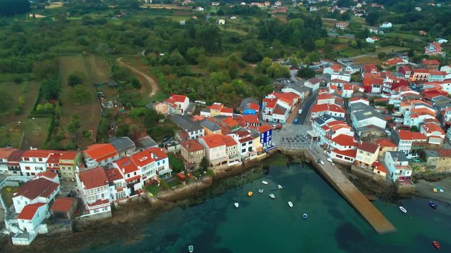 Aerial overview of beautiful houses near the coastal line in Redes, Spain
