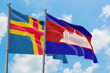 Cambodia and Aland Islands flags waving in the wind against white cloudy blue sky together. Diplomacy concept, international relations.