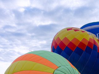 Fototapeta premium Balloons on the ground. Balloonists prepare the balloons for flight. Festival of aeronautics.
