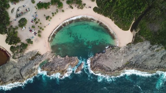 Mar Chiquita Beach, Puerto Rico. Top Down Aerial View of Unique Lagoon and Ocean Waves Breaking on Natural Rampart