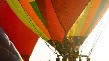 Fire warms the air in a balloon. Balloonists prepare the balloons for flight. Festival of aeronautics.