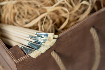 New wooden paint brushes set on light background