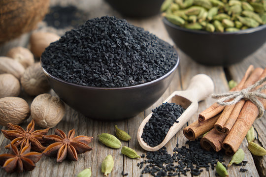 Healthy black cumin or roman coriander seeds and aromatic spices: cardamom, nutmegs, cinnamon sticks. Ingredients for cooking. Ayurveda treatments.