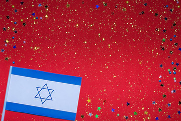 Independence Day of Israel. Flag of Israel on a festive red background. The concept of celebration,...