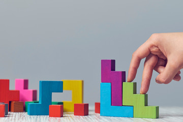 Stacked cubes and female hand imitating walking upstairs against white background. Concept of...