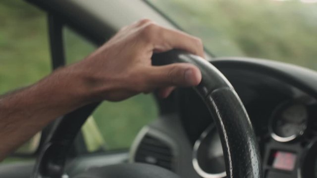 Driver's Hands On Steering Wheel Inside Of A Car.