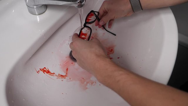 Washing murder evidence spectacles immersed in blood