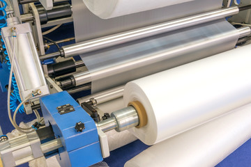 The operation of automatic plastic bag production machine. Close-up of the roller of the...