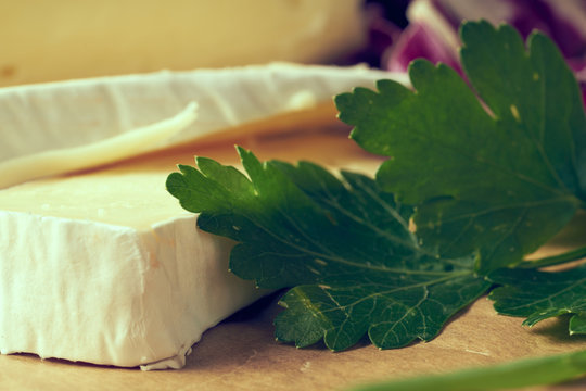 White Delicious Homemade Camambert Cheese On A Wooden Plate Served With Almonds, Cashew, Pine Nuts And Peach. Dessert For A Family Dinner. Brie.