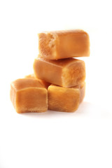Brown caramel cubes isolated on white background