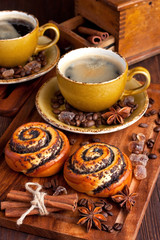 Cup of coffee and tasty  sweet buns on  wooden background