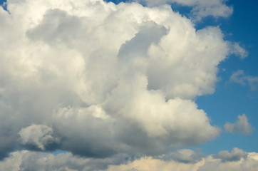 Blue sky with big white and grey clouds.