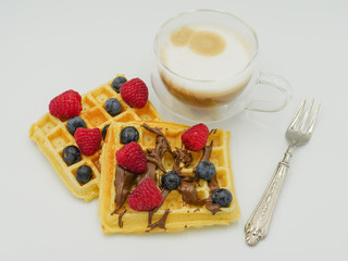 Fresh waffles with berries and coffee