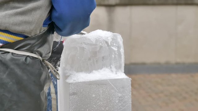 Man chiseling at ice block. Static, slomo