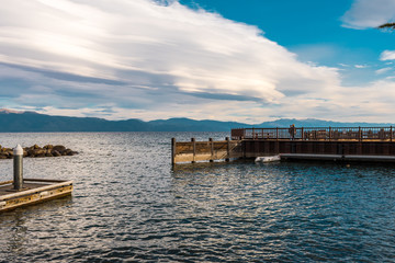 Tourists enjoy the sunset with their smartphone from a dock in Tahoe Vista