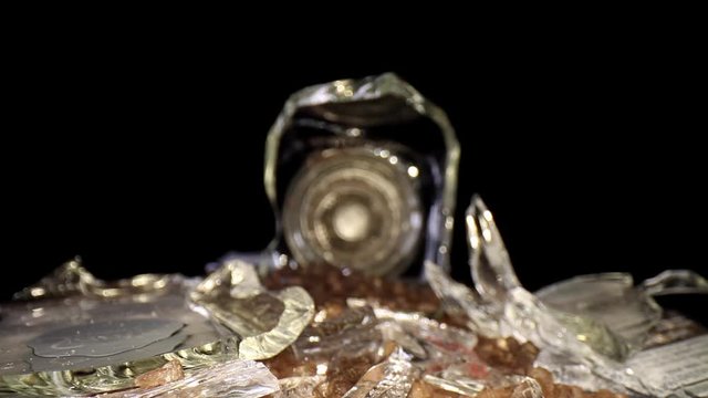 Pulling away from a broken sea salt grinder, with the broken glass and salt intermixed - salt is mesquite flavored hence the darker color. glass is primary focus to start and then salt at the end.