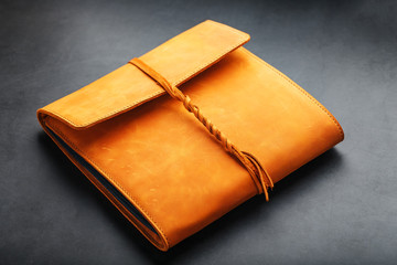 Photo album with blank black for photos. Split rings for close-up macro albums.The album cover is made of brown handmade genuine leather on a black background.