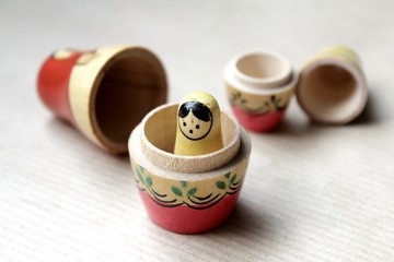 Wooden Russian matryoshka dolls in folk style, girls with painted dresses and veiled heads covered...