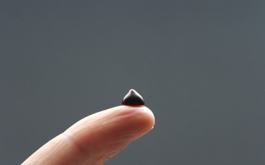 Dark bitter chocolate chips in the shape of drops, for cooking pastry or use in food decor.
