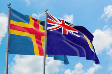 Turks And Caicos Islands and Aland Islands flags waving in the wind against white cloudy blue sky...