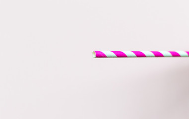 Single Paper straw on pink colour background