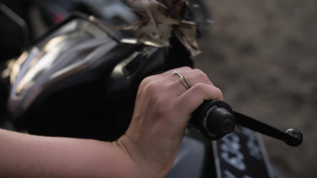 Revving throttle on scooter in Bali Indonesia.