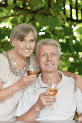 Portrait of cute old couple drinking wine
